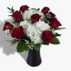 Grand Romance is a luxurious rose-forward vase arrangement designed for unforgettable moments.