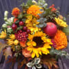 This wildflower jar is composed of seasonal autumnal flowers including sunflowers, mums