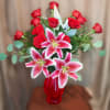Elegant red roses mixed with fragrant stargazer lilies, creating a lush, romantic