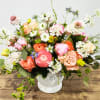 The beautiful arrangement is made with peony ranunculus in shades of pink