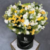 A vibrant and beautiful arrangement of sun-kissed flowers in our signature olive