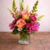 This elegant vase features a beautiful arrangement of pink and purple flowers