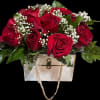 A dozen red roses in a purse container of your choosing with