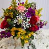 Mixed flower arrangement in a wooden base. It measures 14-16 inches tall.