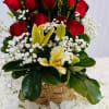 An arrangement of 9 red roses with lilies and baby's breath on