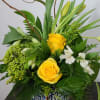 The cool blues in the tile inspired vase of this arrangement lend