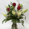 Simple and Elegant roses and lilies arranged beautifully in a vase with