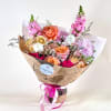 A soft and romantic hand-tied arrangement designed with a lush mix of