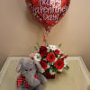 A valentine's Day arrangement with a valentine's Day plush elephant and balloon