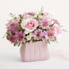 The ultimate arrangement for your favorite fashionista. A profusion of roses, poms
