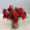 This classic arrangement features a lush gathering of deep red roses nestled