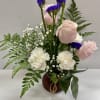 A small of pink roses and white carnation arrangement , a sweet