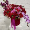 Exotic and Romantic floral arrangement in a burgundy velvet gift box. Two