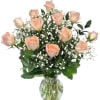 Long stem peach roses arranged with premium greens in a tall vase.