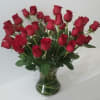 Three dozen roses arranged in a vase