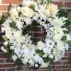A classic Sympathy Wreath, designed with uplifting, traditional blooms and fresh varied