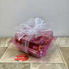 This charming candy box features a clear pink container filled with shimmering