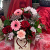 This wooden box is filled with Roses, Gerber Daisies, Alstromeria, and mixed