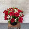 A regal and timeless arrangement of rich red roses accented with delicate