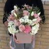 The charming bouquet includes tulips, carnation, hydrangeas and more