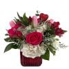A vibrant and romantic arrangement designed in a mercury red glass cube.