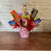Pink and red heart container with an assortment of candy 
