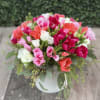 This colorful arrangement includes assorted godetia flowers with dragon and eucalyptus in