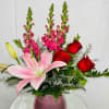 A beautiful mix of roses, lilies and snapdragons come together in a