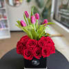 This elegant floral arragement features fresh tulips as the main attraction, symbolizing