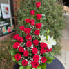 This stunning floral arragement features lush red roses, the ultimate symbol of