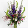 This is a very large impressive arrangement. Hybrid delphinium, stargazers, hot pink