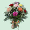 Twelve mixed color carnations in a vase with baby's breath and greenery.