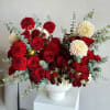 A luxurious arrangement featuring rich red roses, delicate spray red roses, and
