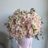 This beautiful arrangement is filled with ranunculus, hydrangeas, beige color roses and