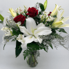 Sweet, classic, and endlessly romantic, red roses with soft white lilies and