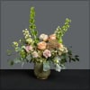 Lush and full arrangement in a lovely neutral art glass vase, created