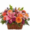 Mixed summer blooms in a woven basket, perfect for any occasion, lilies