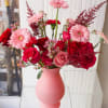 This lush vase arrangement captures the dreamy essence of soft pink gerberas