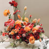 A statement-making, grand floral arrangement designed to captivate. Vibrant Reds, Peaches, and