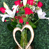 A lovely wood-colored vase adorned with a wooden heart, filled with classic