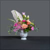 Funky face vase with a "hat" of flowers, including an ostrich feather.
It's