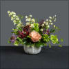 Fun ribbed bowl filled with and assortment of helleborus, roses, scatiosa, hypericum