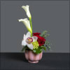 Pink stripe cup with calla lilies, roses, carnations, hydrangea, and a cymbidium