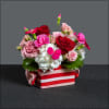Fun arrangement in a vibrant candy bowl filled with antique carnations, hydrangea