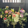 This arrangement is uniquely crafted with fresh light colored blooms. Florals may