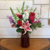Red roses, stargazer lilies and hot pink spray roses with white snaps