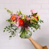 This arrangement is uniquely crafted with the a variety of fresh spring