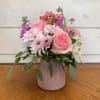 Pale pink roses, pink stock, lavender cushions, and pink hypericum in an