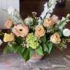 This arrangement is uniquely crafted with peaches in mind. Florals may vary