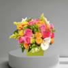 A bright colorful mix of roses, orchids, mini green hydrangea, and green